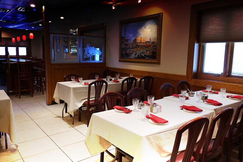 Dining room with two tables set for six and eight