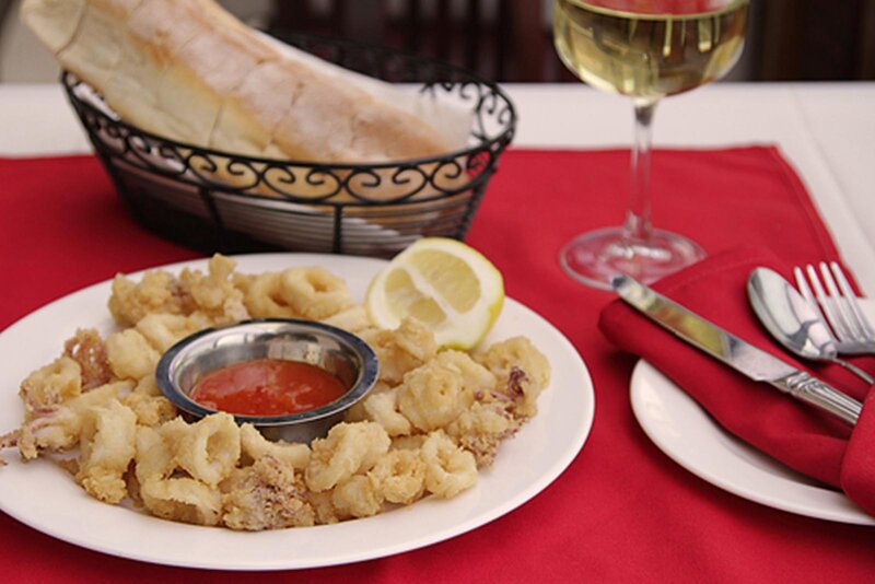 Fried calamari appetizer with a basket of bread