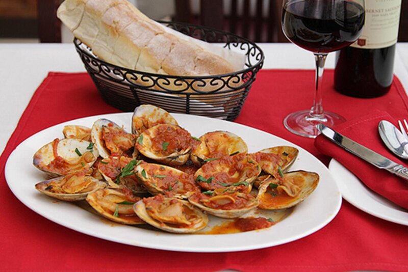 Clams appetizer with a basket of bread