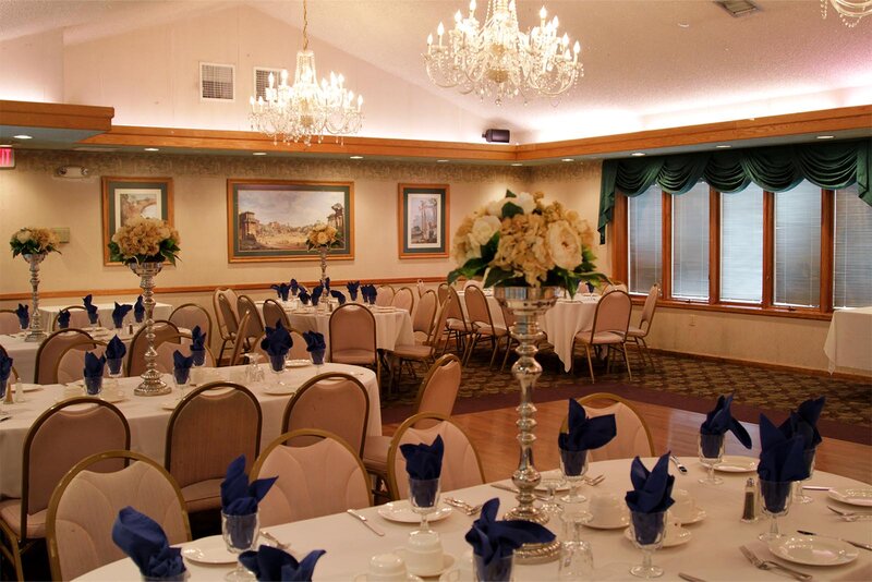 Party room with set tables and chandeliers
